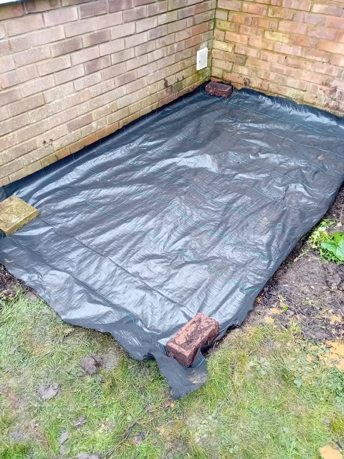 Ground preparation with professional weed-control membrane laid before patio installation in Beeding.